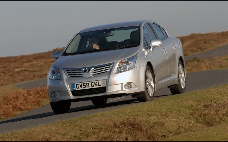 silver sedan on country road