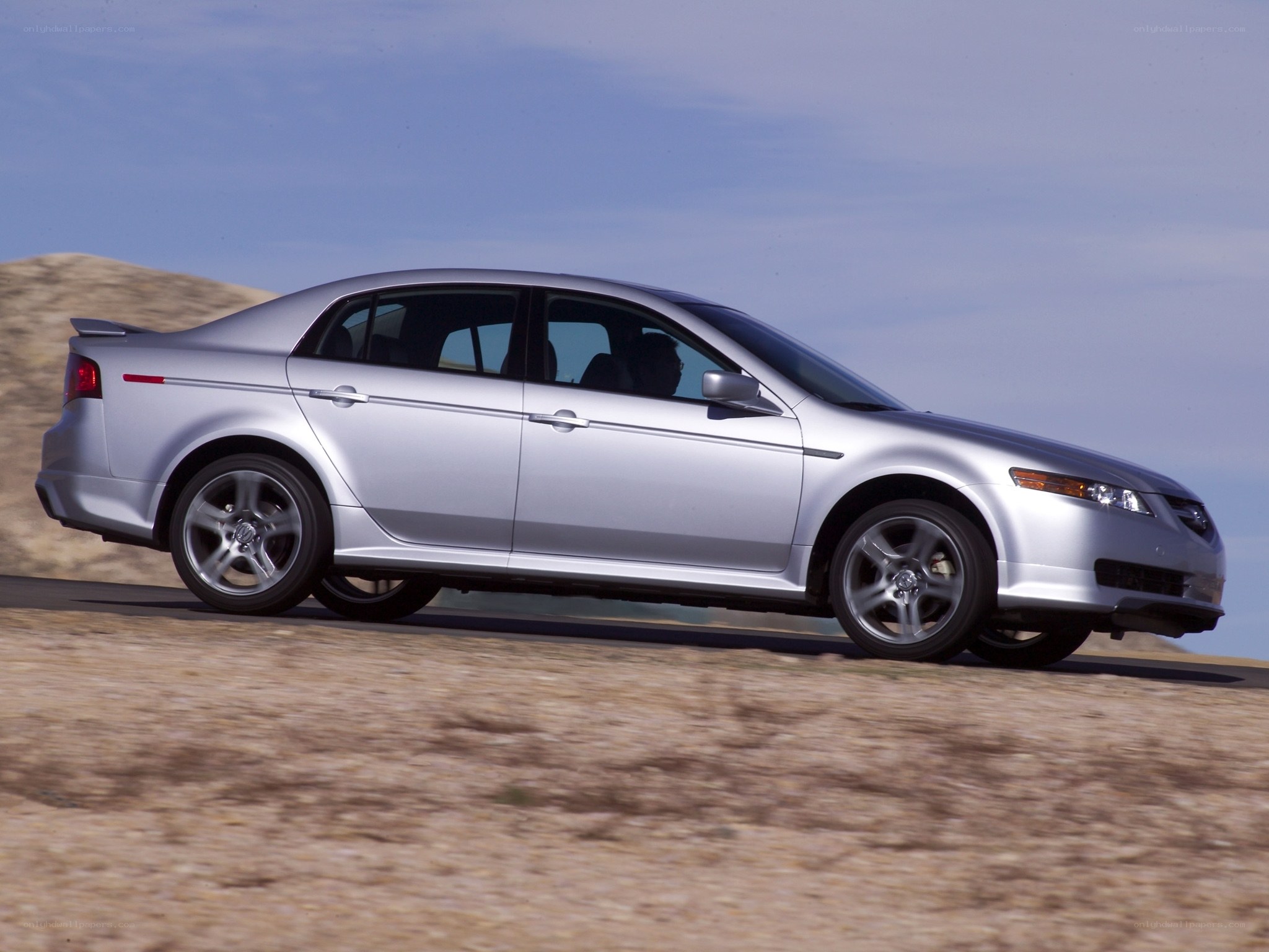 silver sedan on desert road