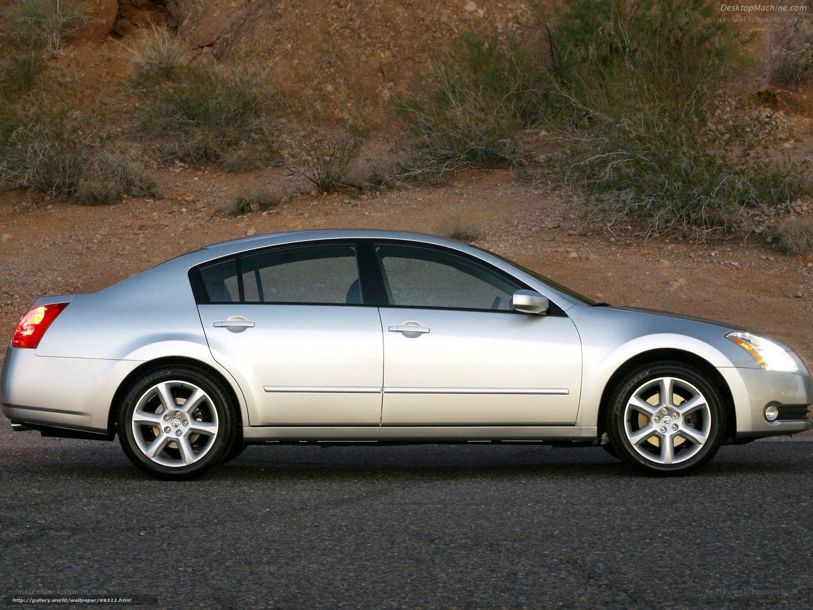 silver sedan on desert road