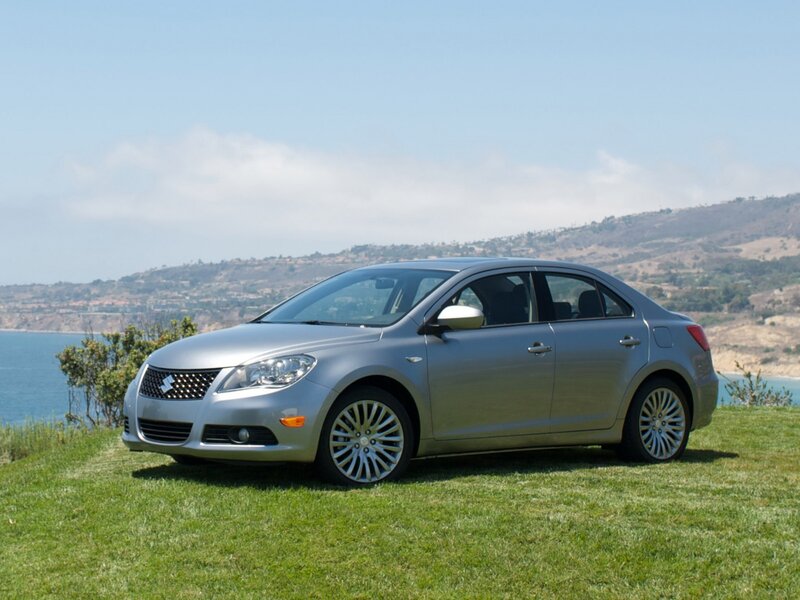 Silver sedan on grassy hill