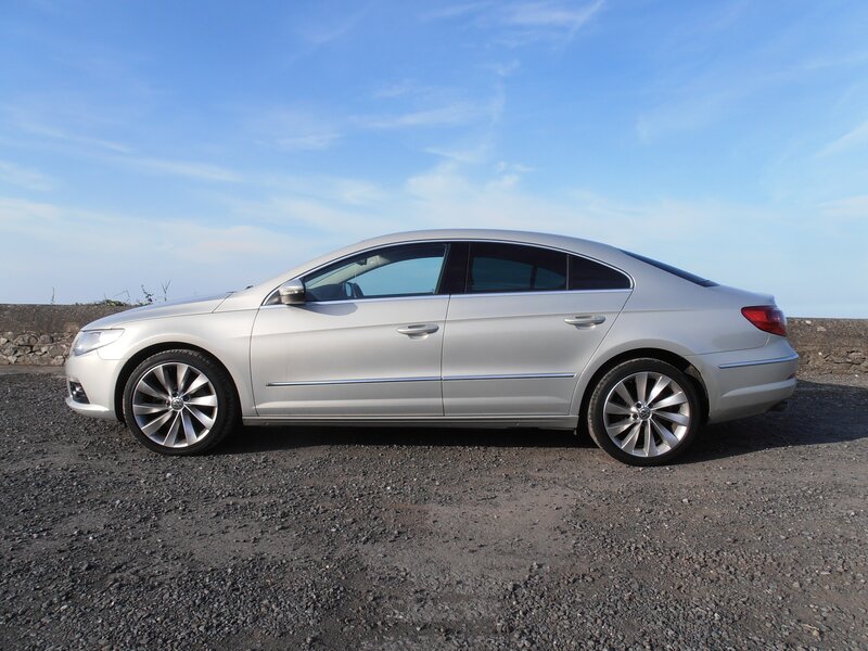 silver sedan on gravel