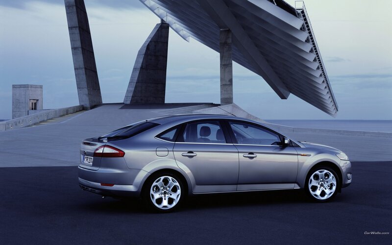 silver sedan on modern bridge