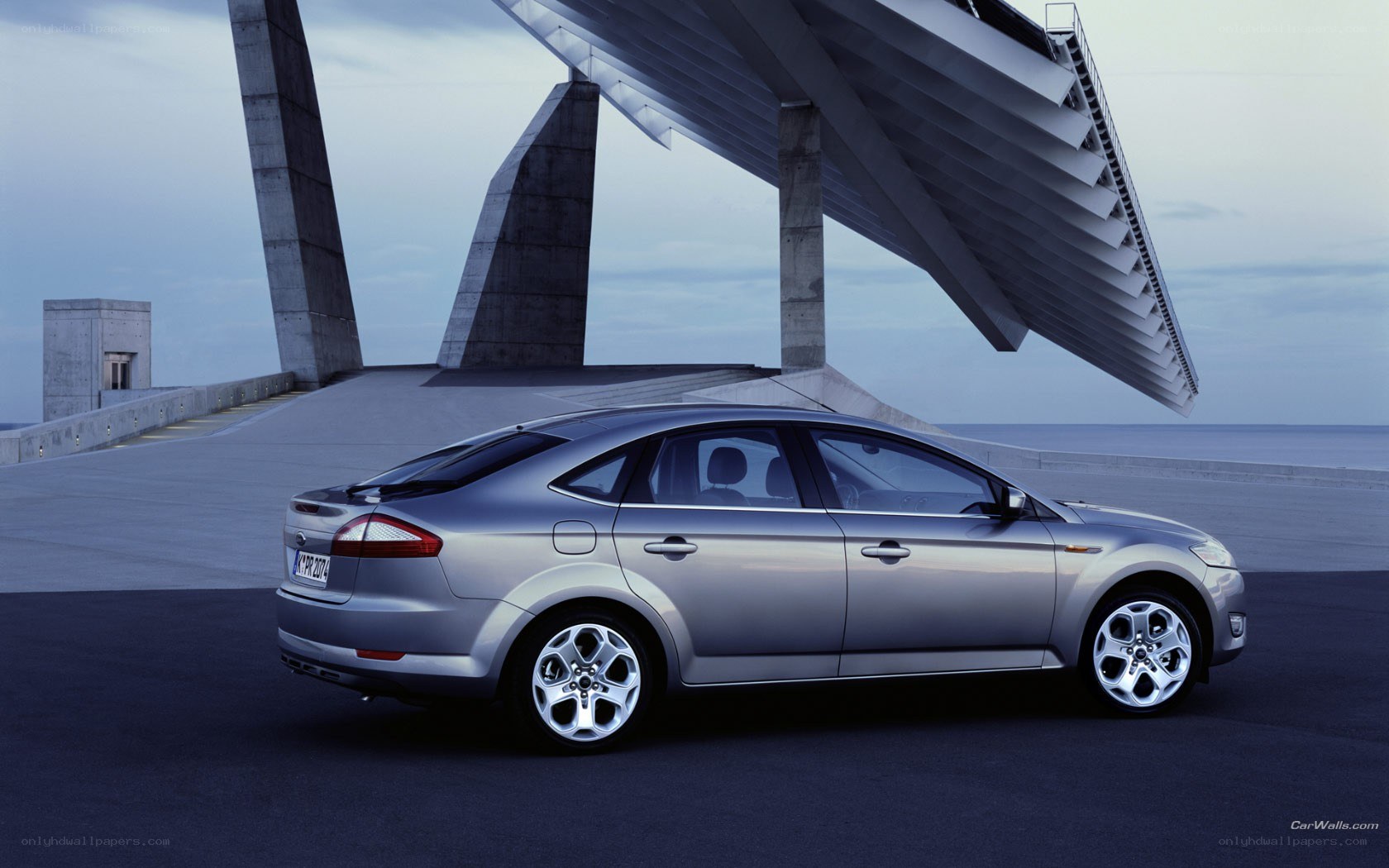 silver sedan on modern bridge