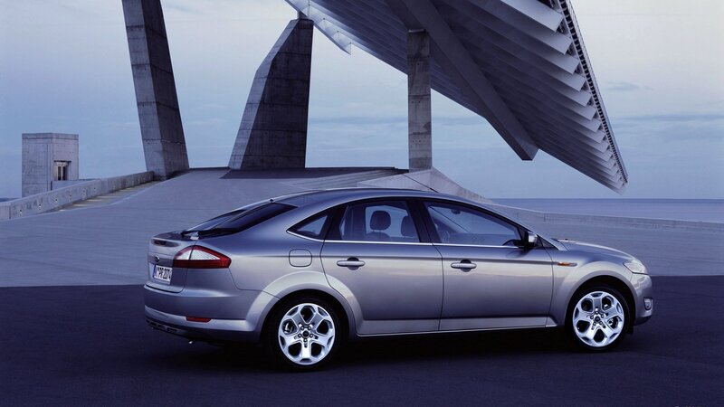 Silver sedan on modern bridge
