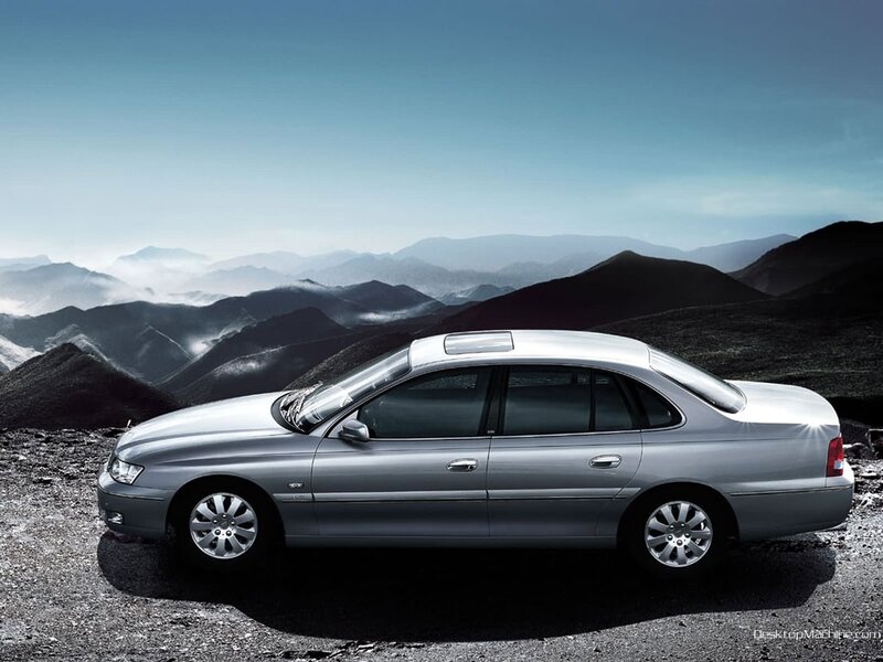 silver sedan on mountain road