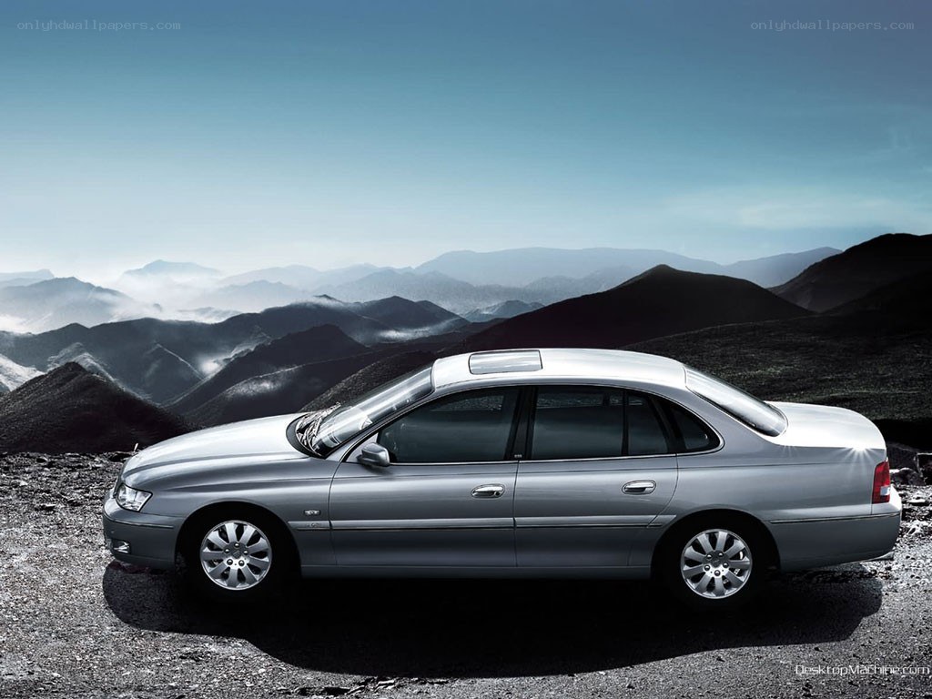 silver sedan on mountain road