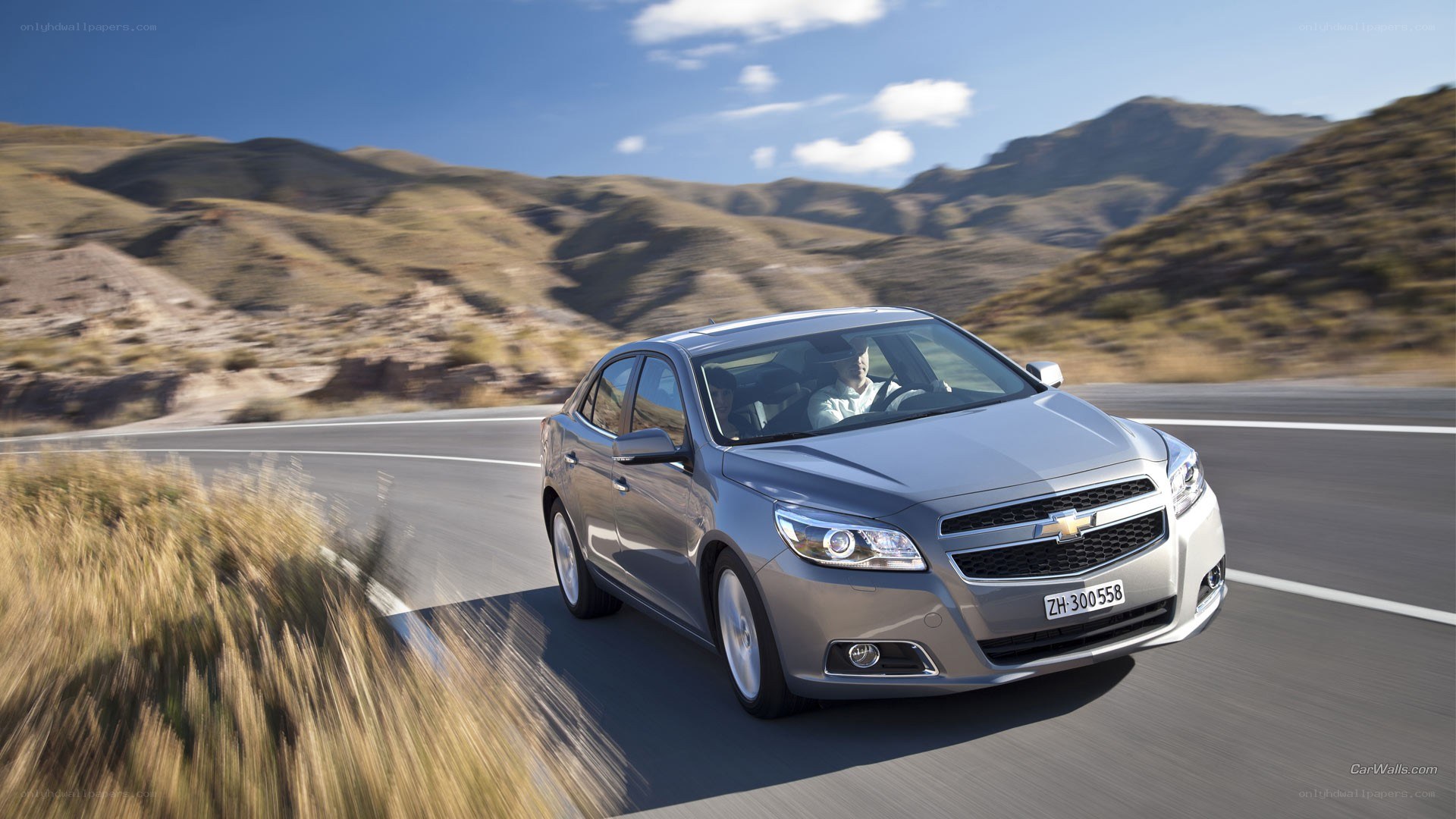 silver sedan on mountain road