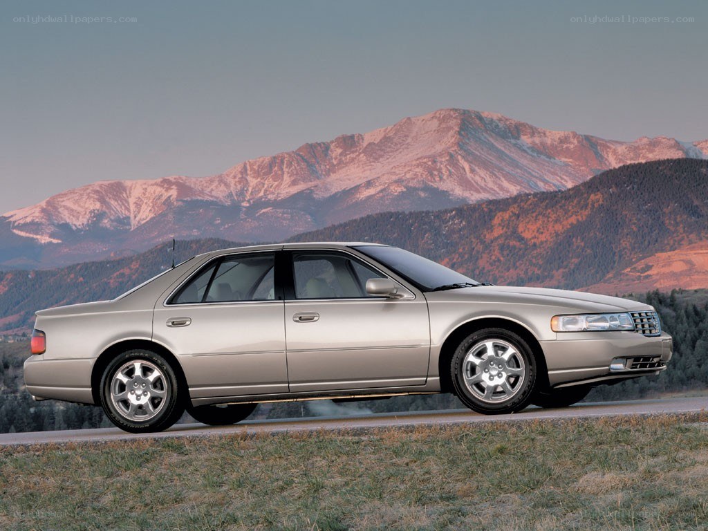 silver sedan on mountain road