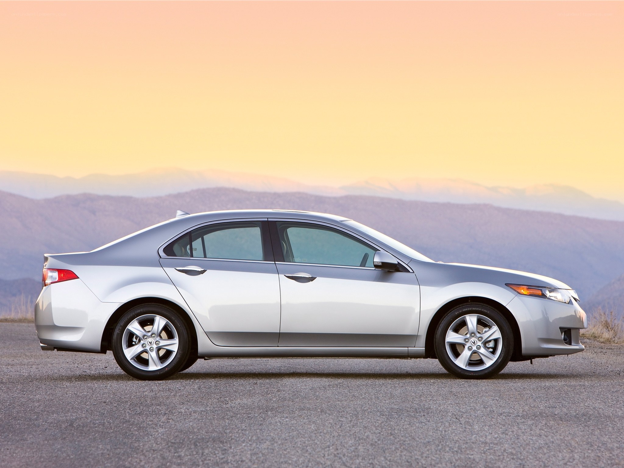 silver sedan on mountain road