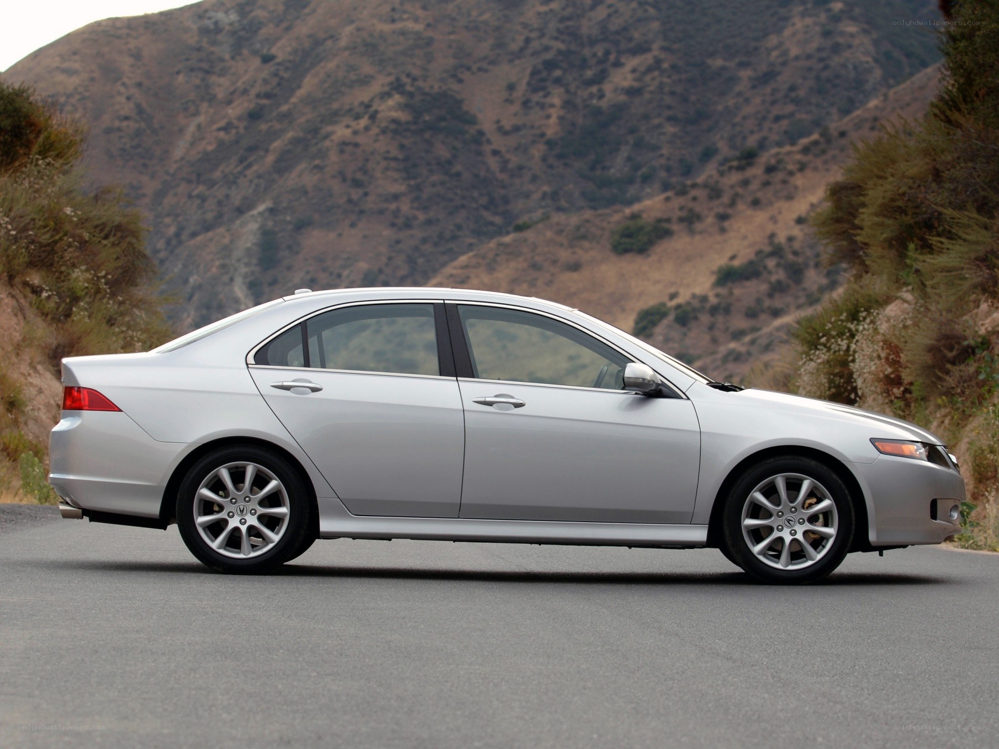 silver sedan on mountain road