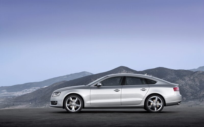 silver sedan on mountain road