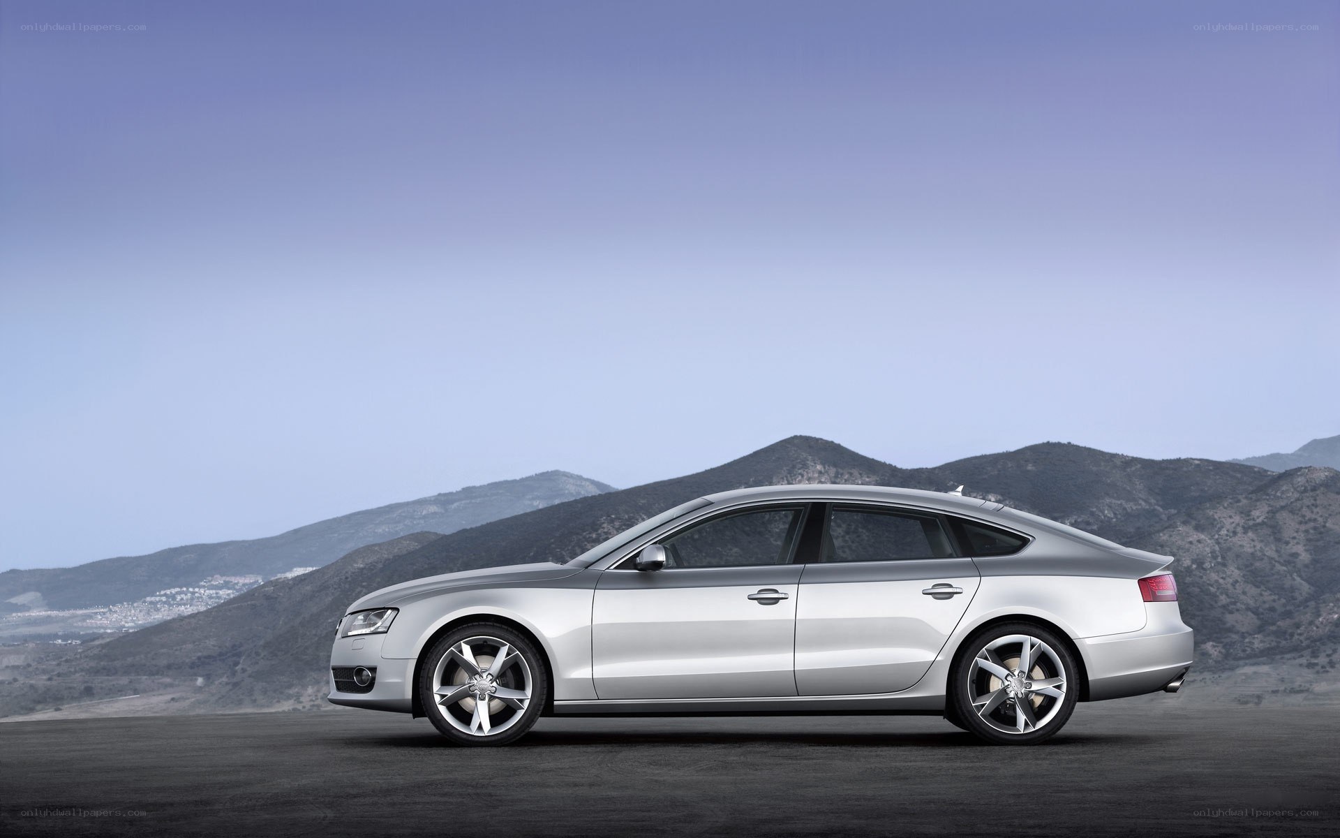 silver sedan on mountain road