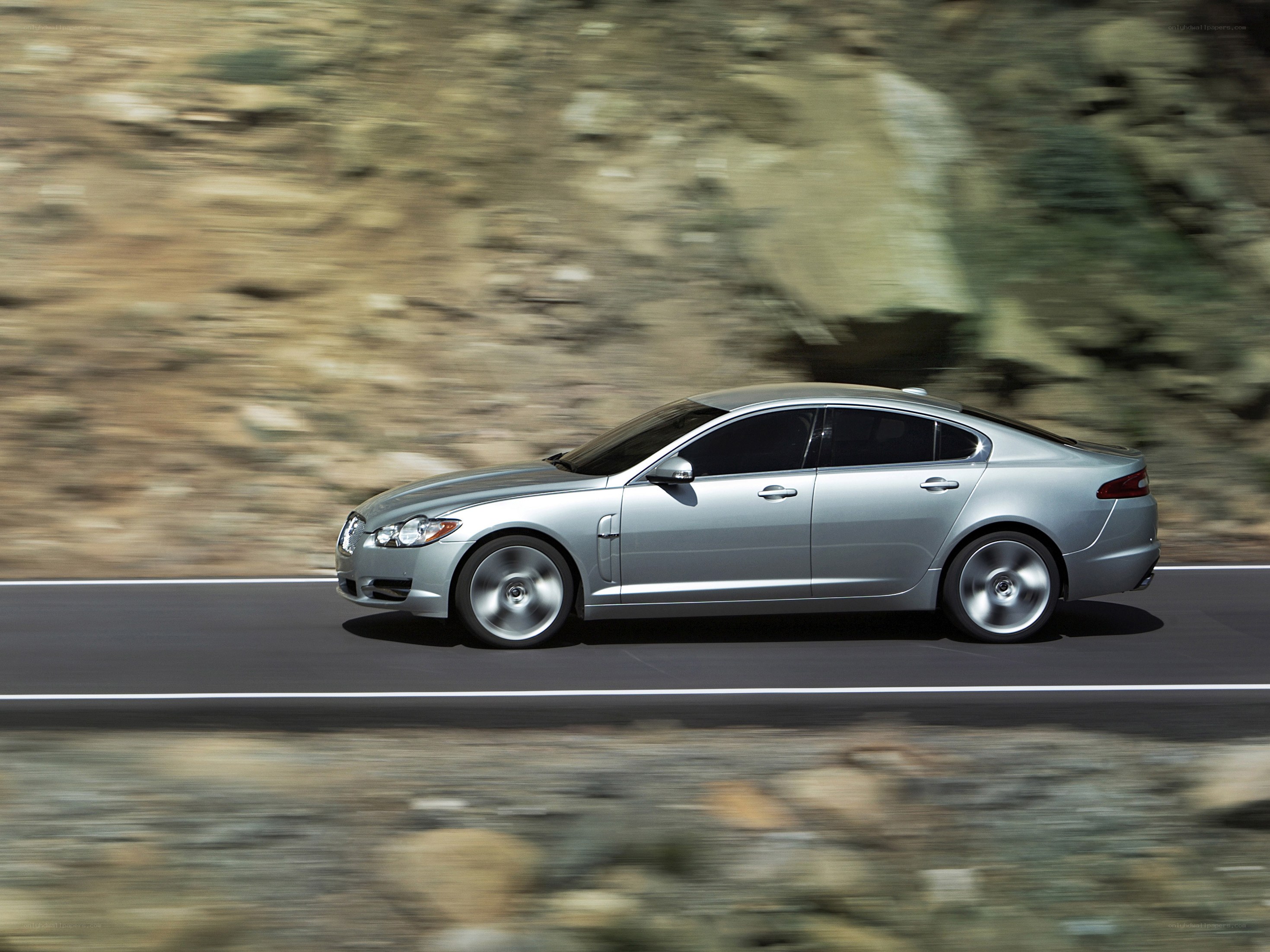 silver sedan on mountain road