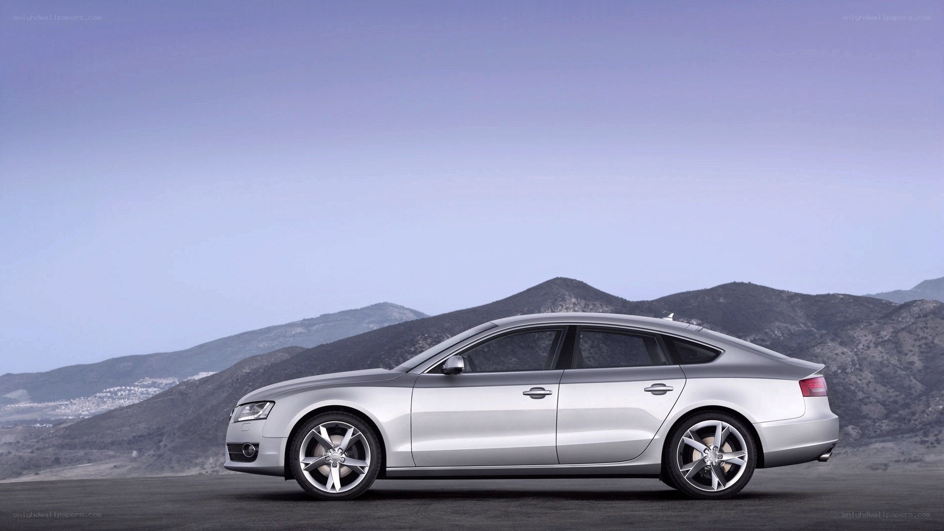 silver sedan on mountain road