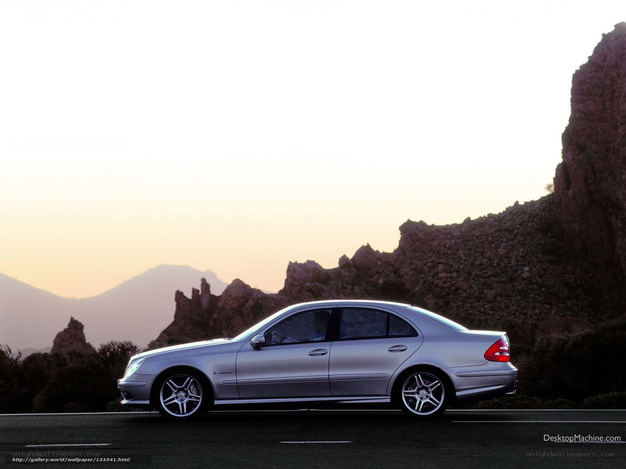 silver sedan on mountain road
