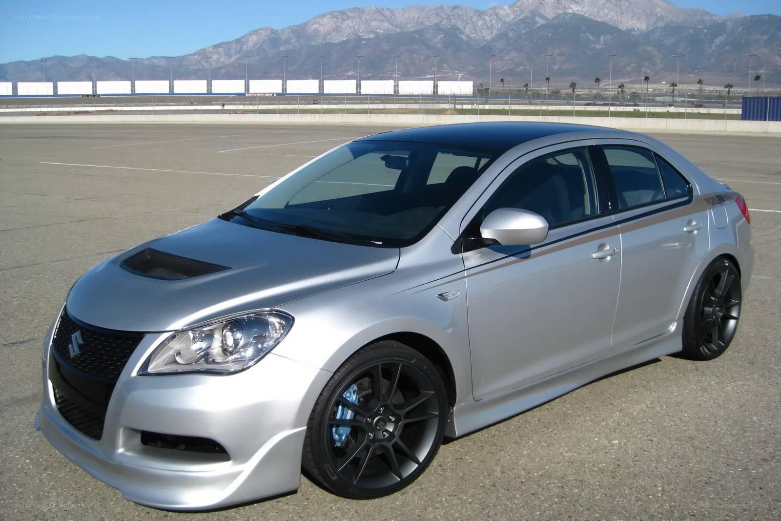 silver sedan on racetrack