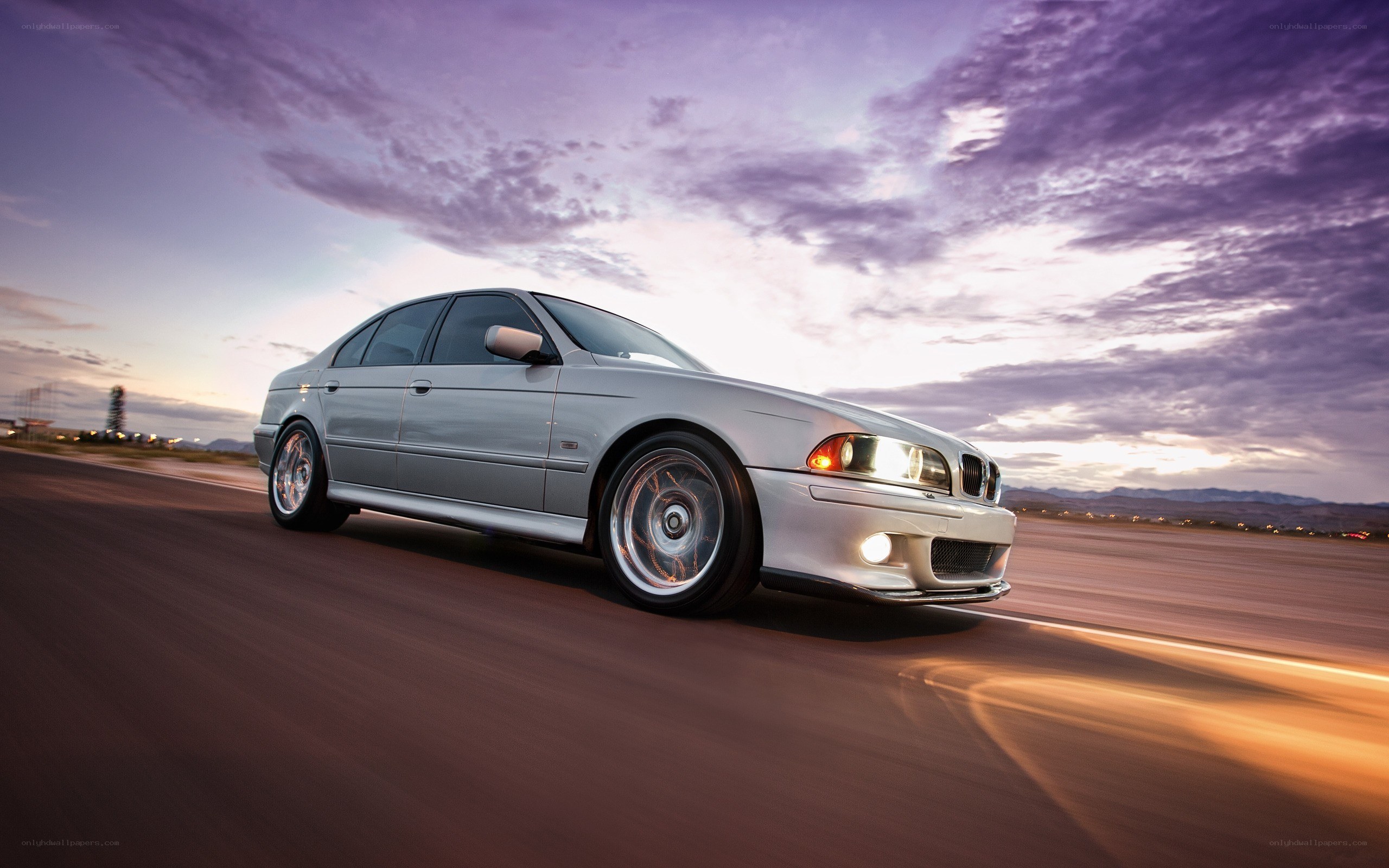silver sedan on road at dusk