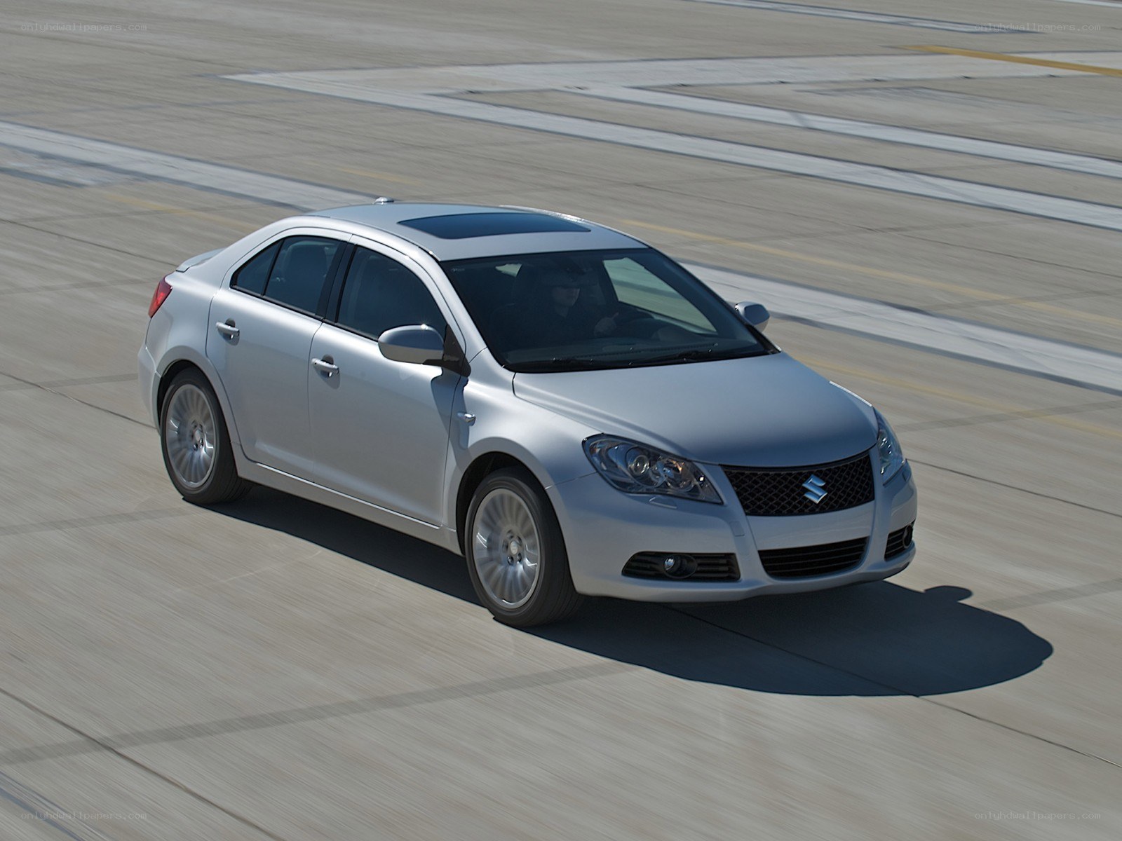 silver sedan on runway