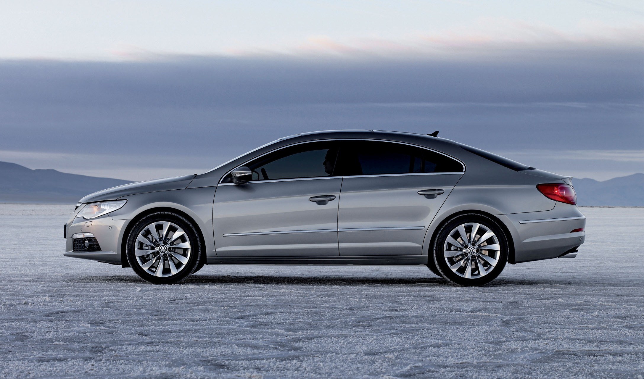 silver sedan on salt flat