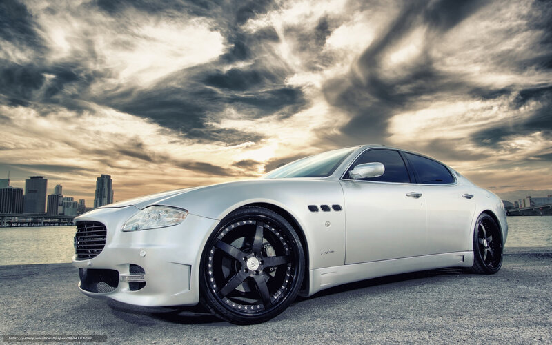 silver sedan on waterfront