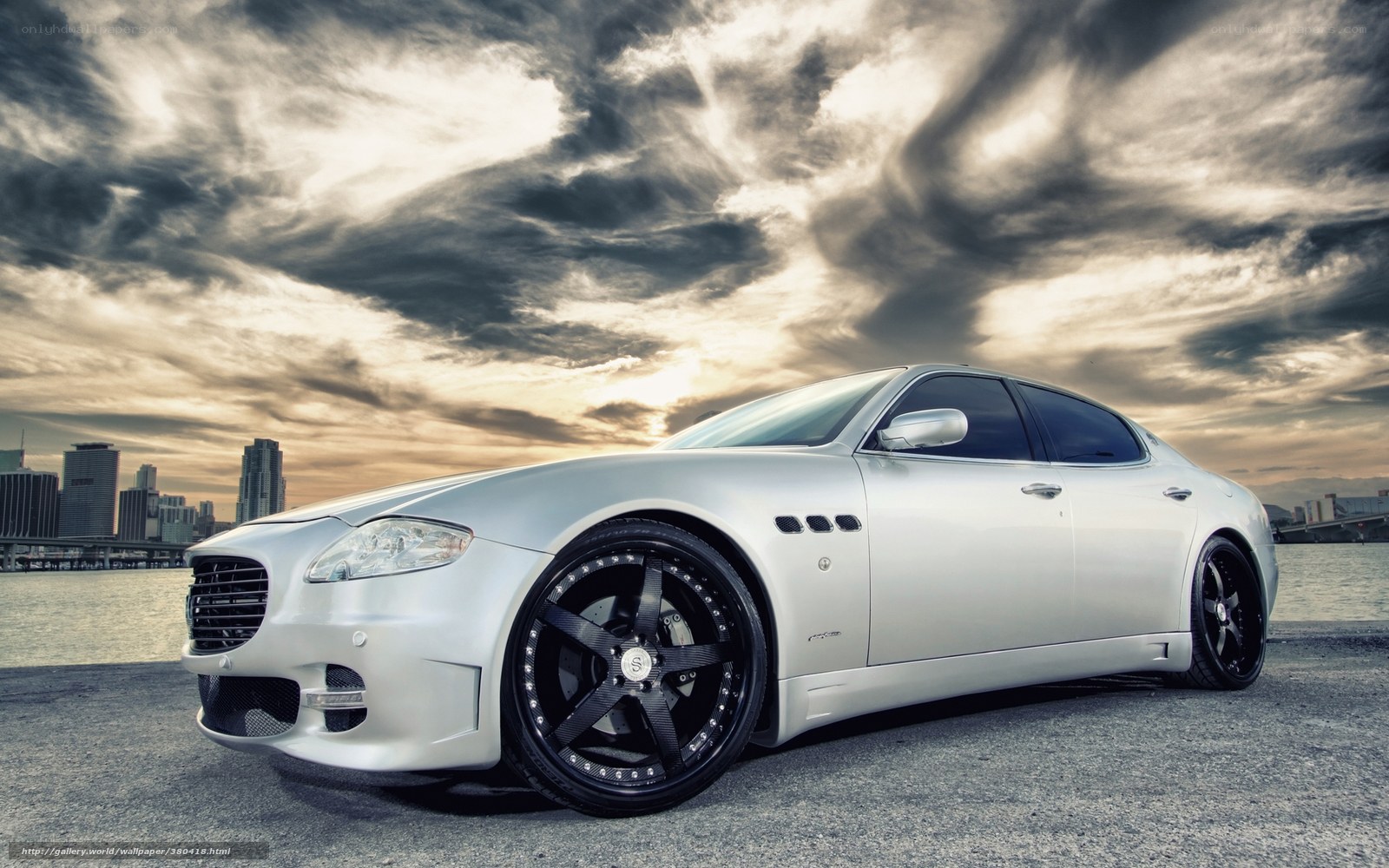 silver sedan on waterfront