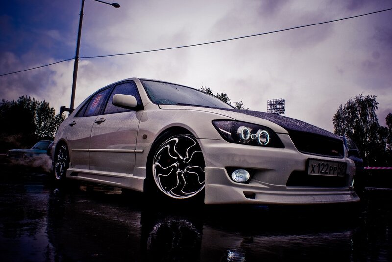 silver sedan on wet pavement