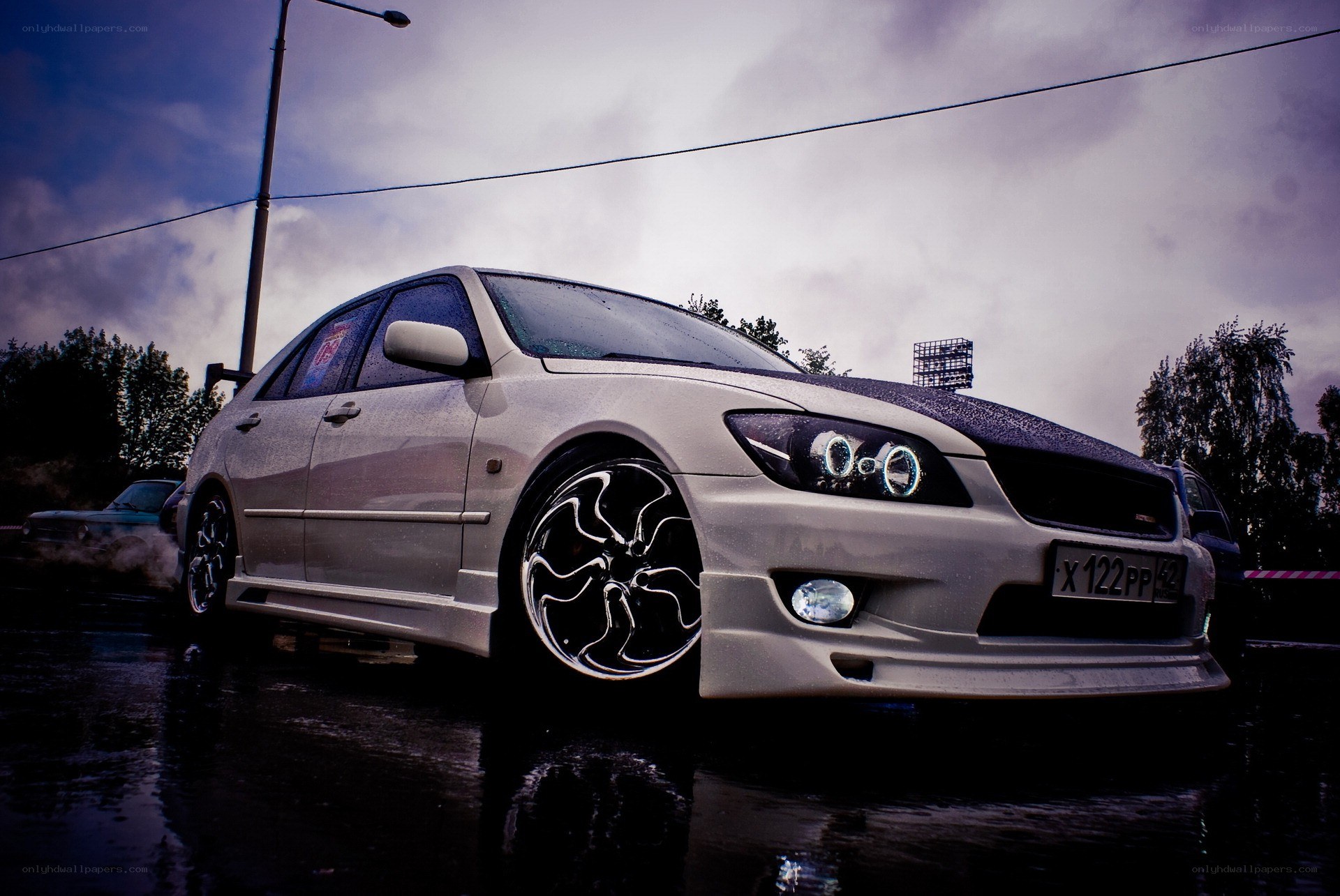 silver sedan on wet pavement
