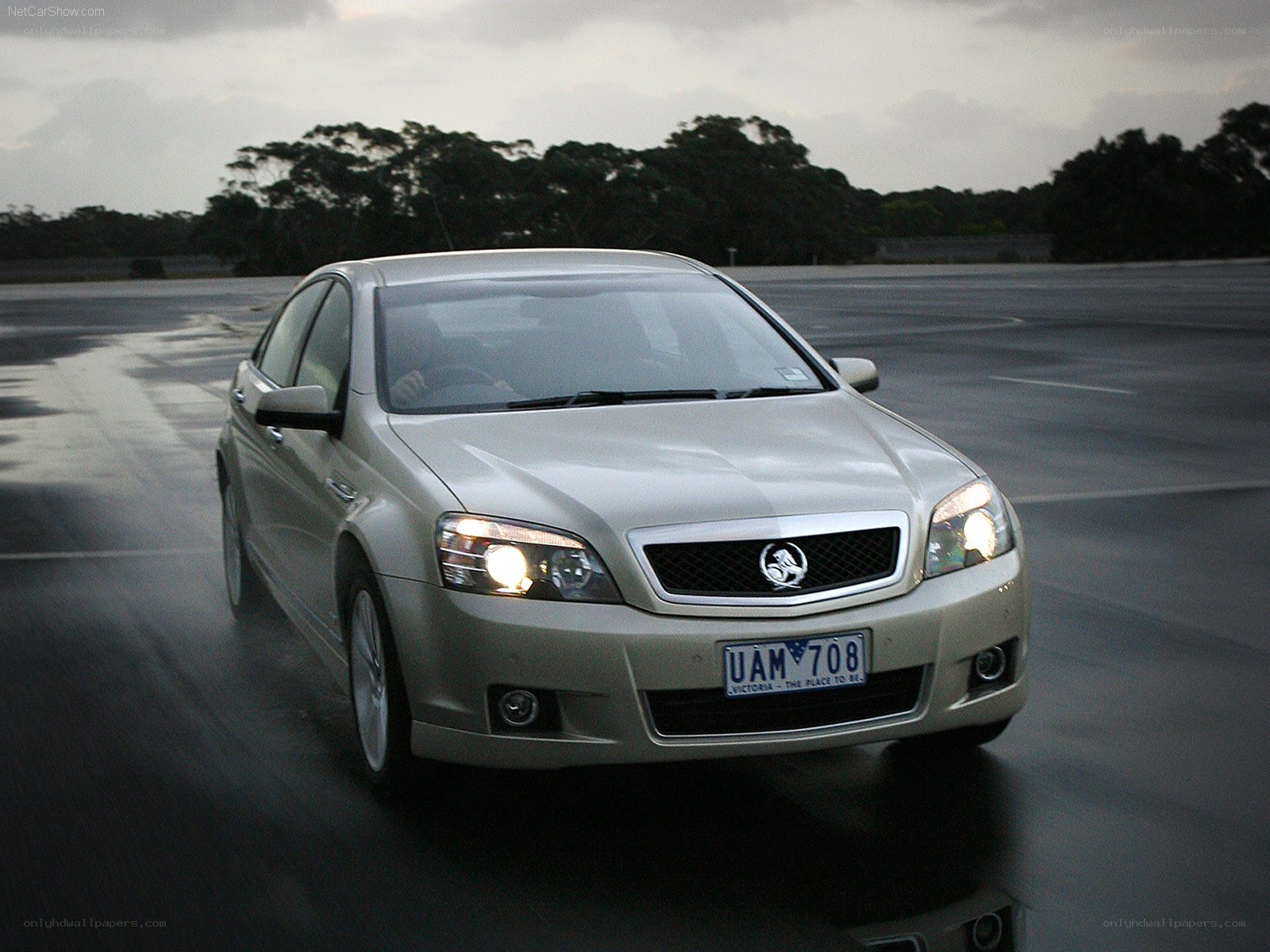 silver sedan on wet road