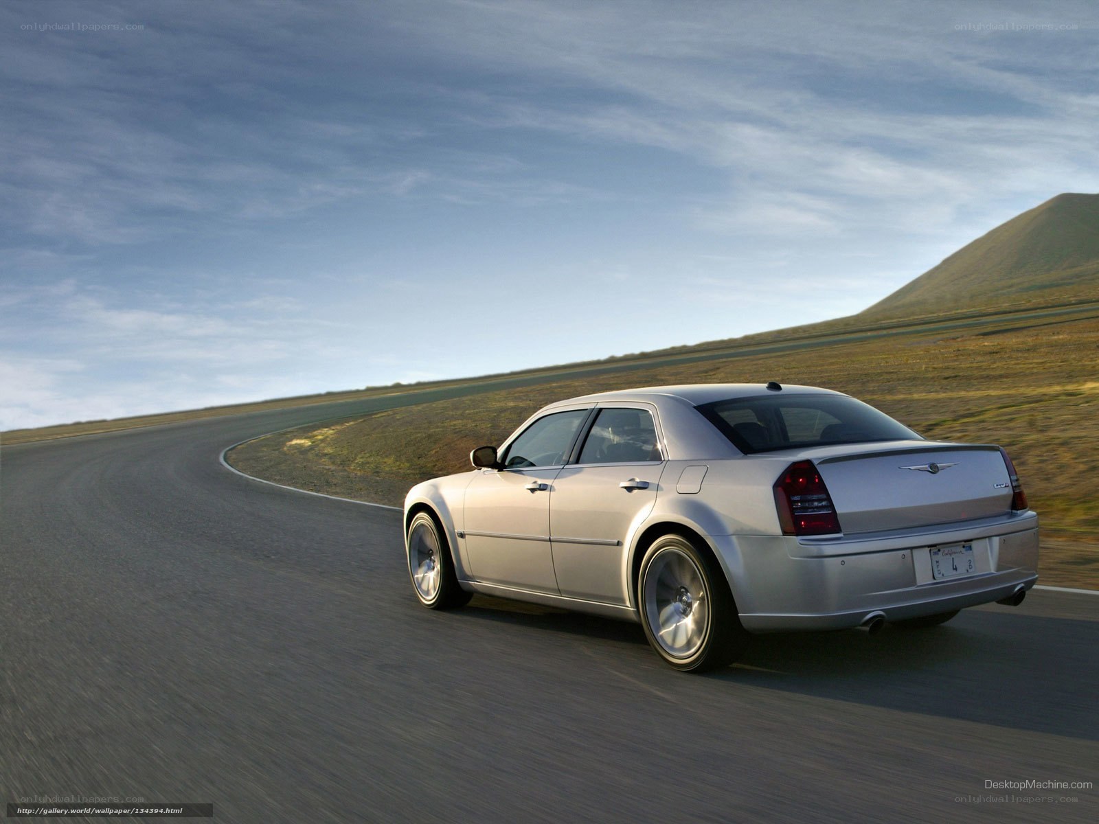silver sedan on winding road