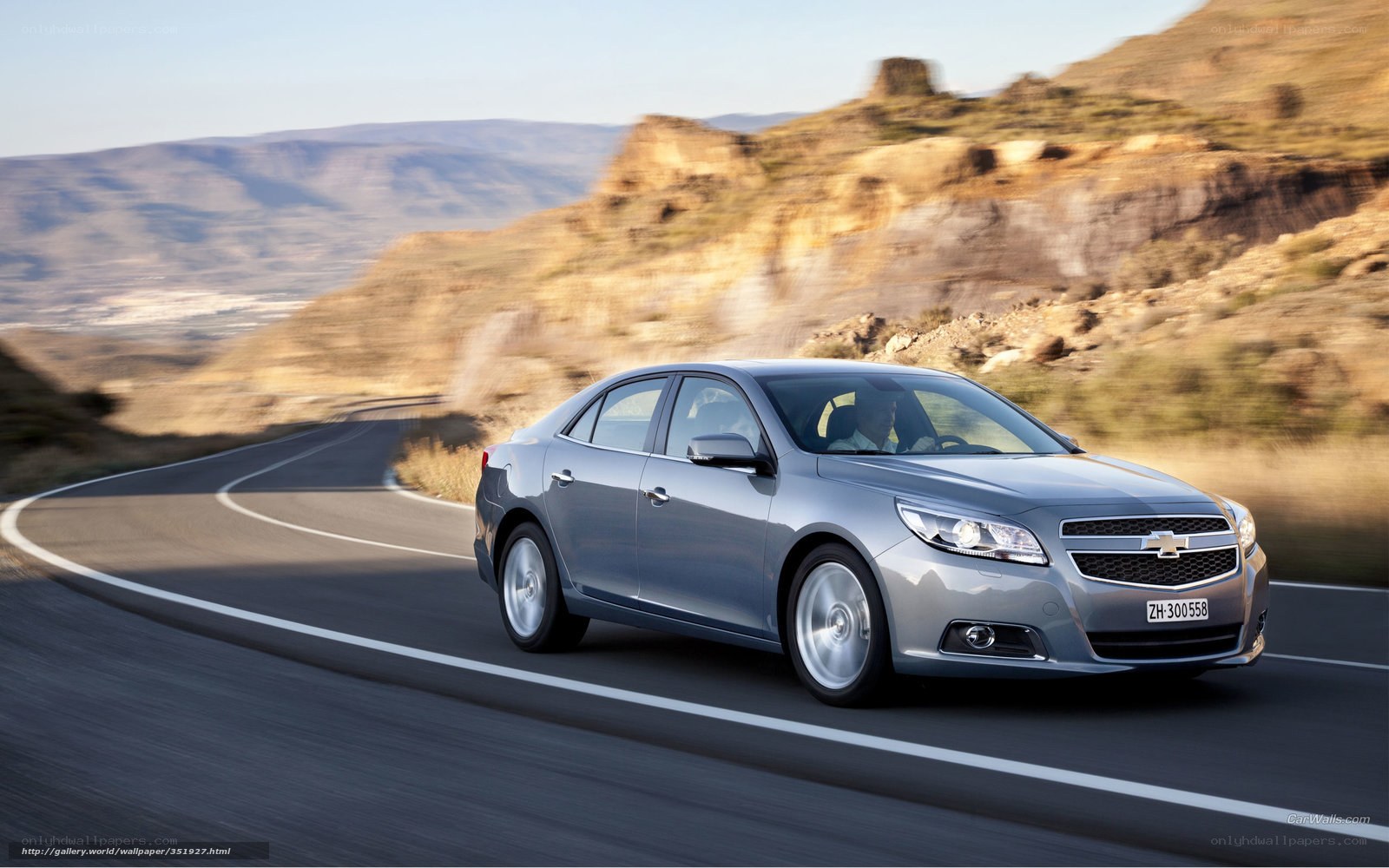 Silver sedan on winding road