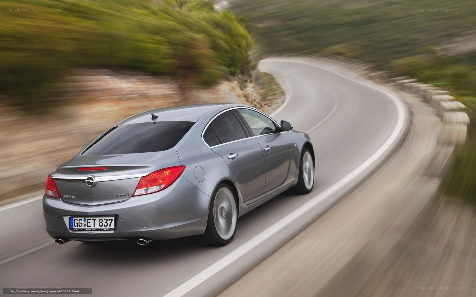 silver sedan on winding road