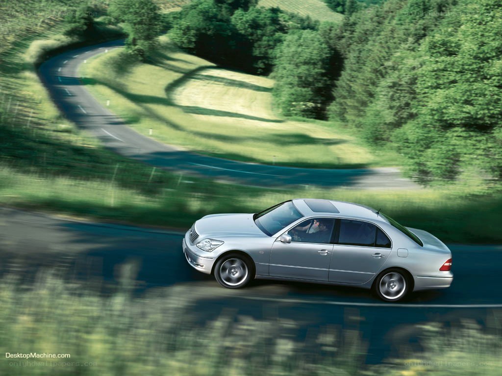 silver sedan on winding road