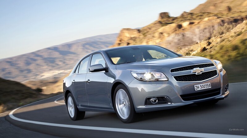 silver sedan on winding road
