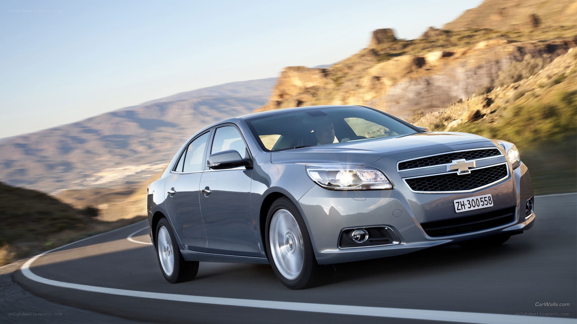 silver sedan on winding road