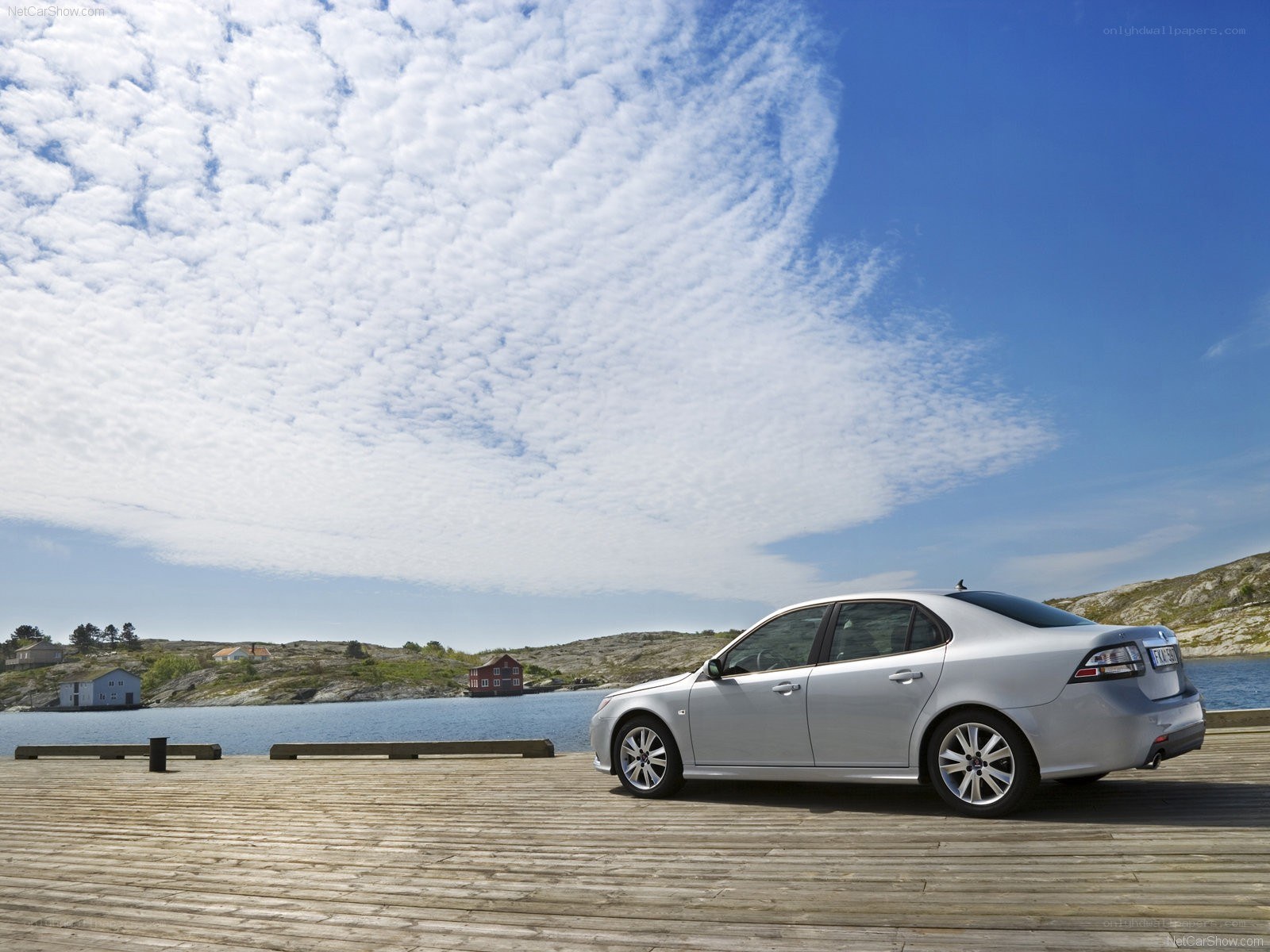 Silver sedan on wooden dock