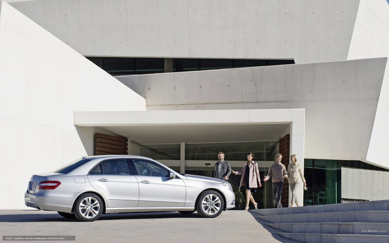 Silver sedan outside modern building