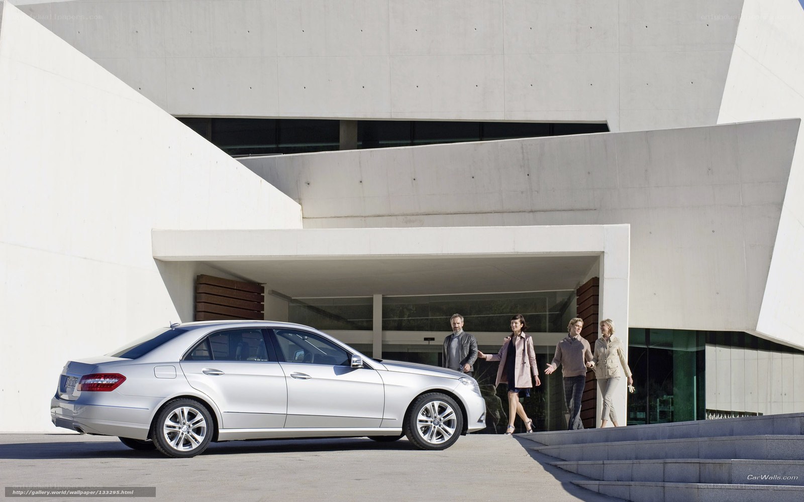 Silver sedan outside modern building