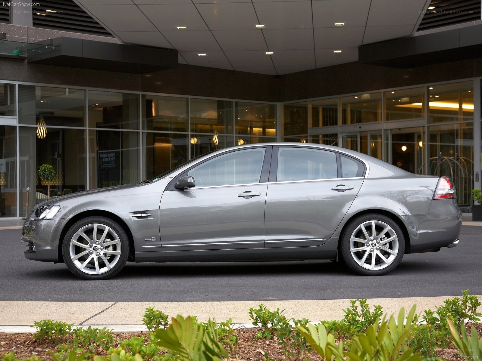 silver sedan parked outside building