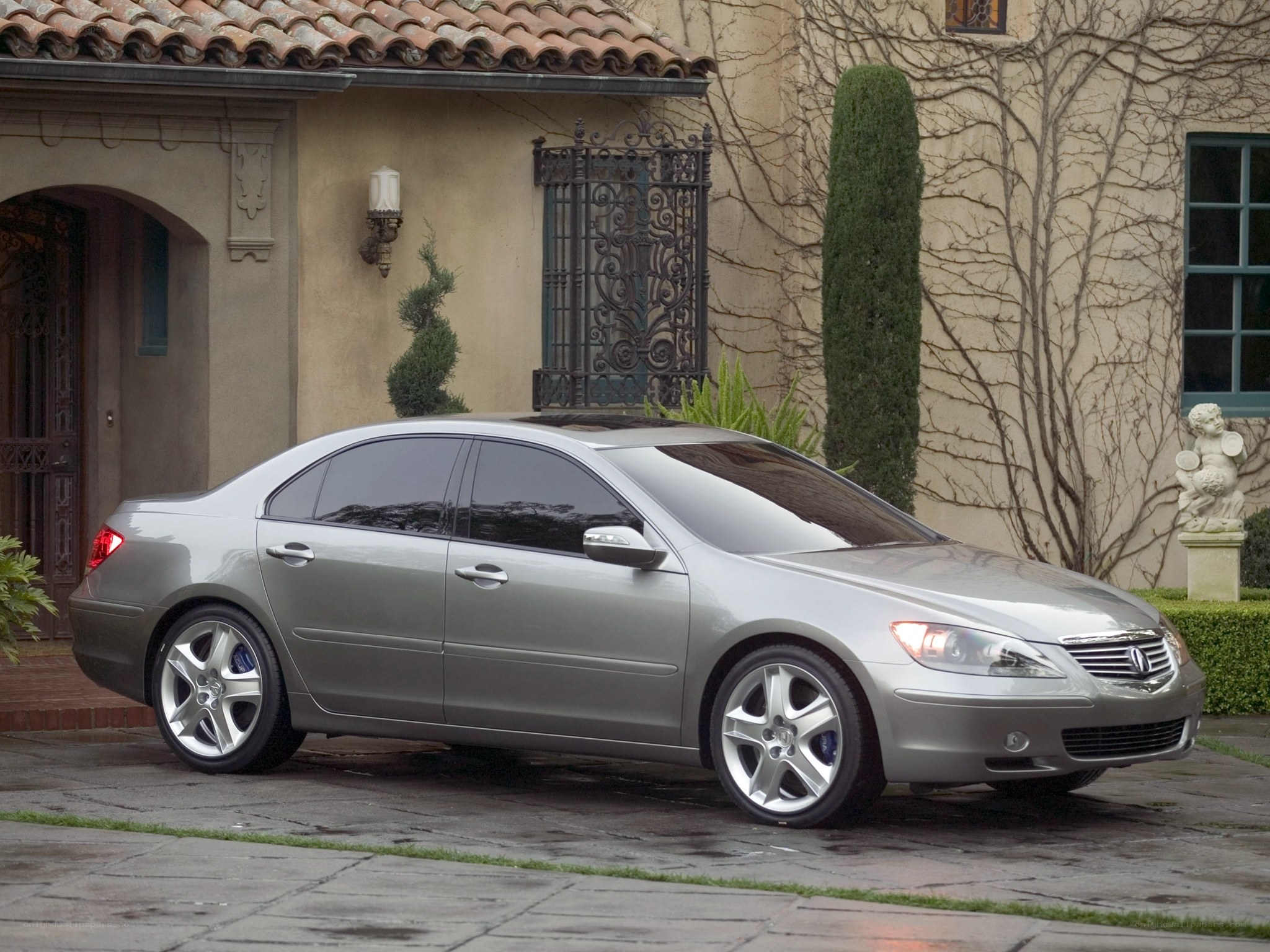silver sedan parked outside house