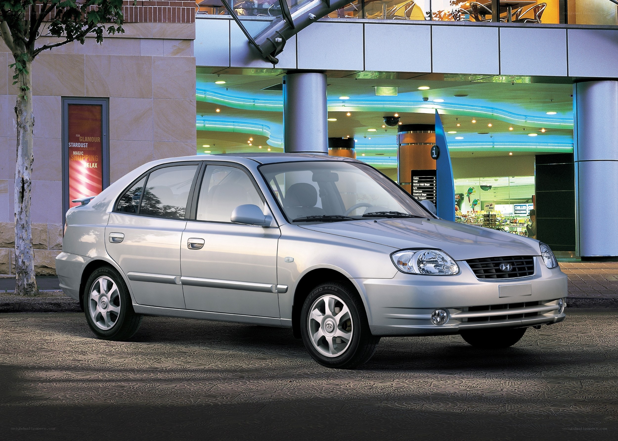 Silver sedan parked outside mall