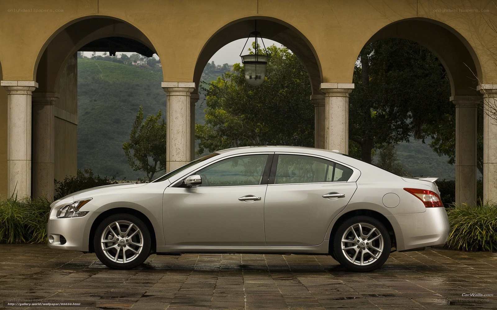 Silver sedan under arches