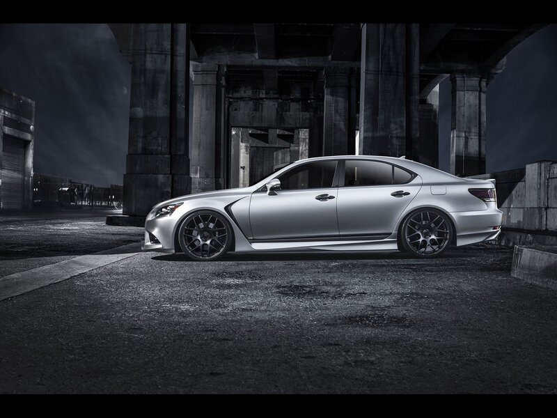Silver sedan under bridge