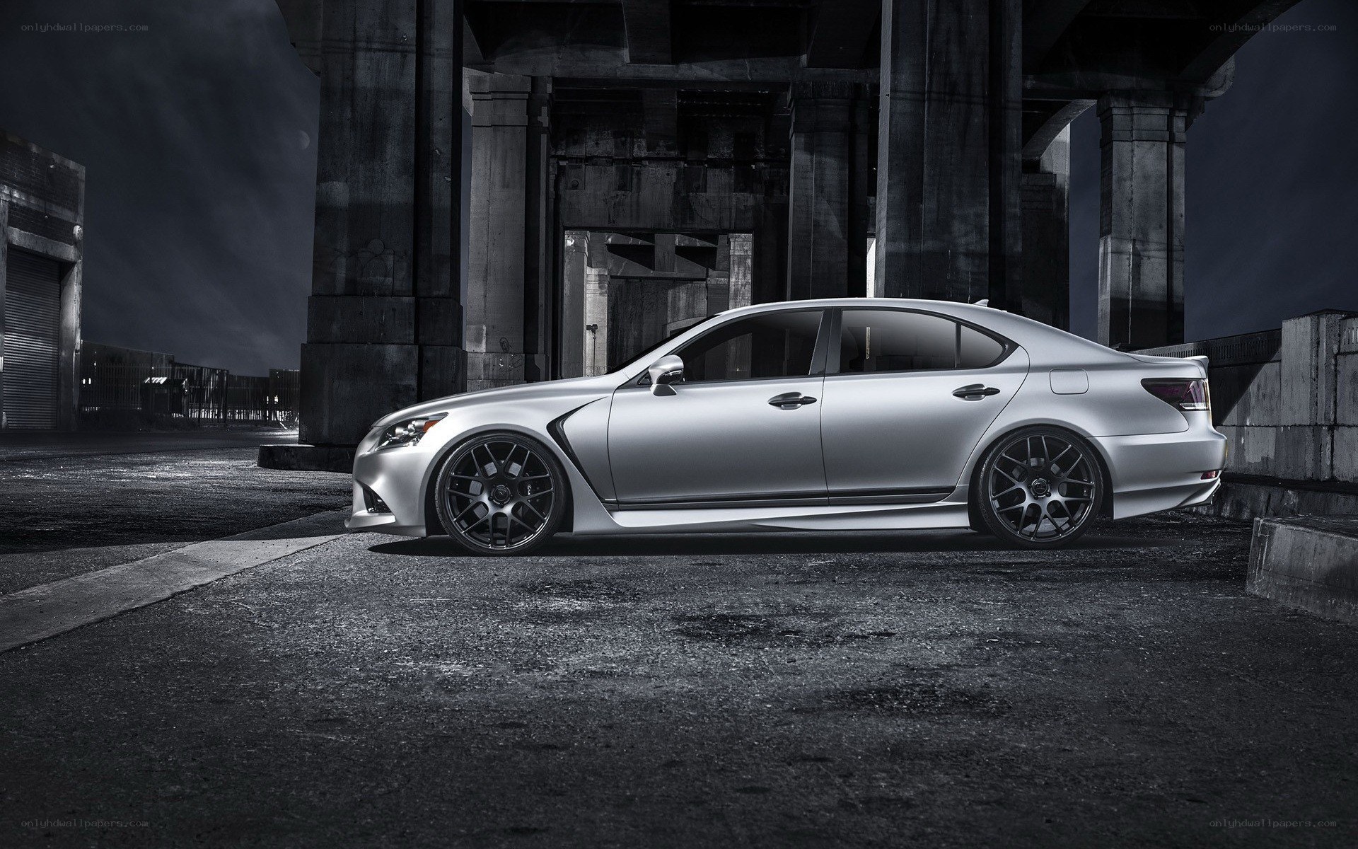 Silver sedan under bridge