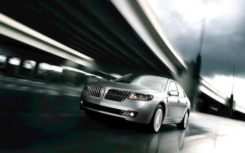 silver sedan under highway