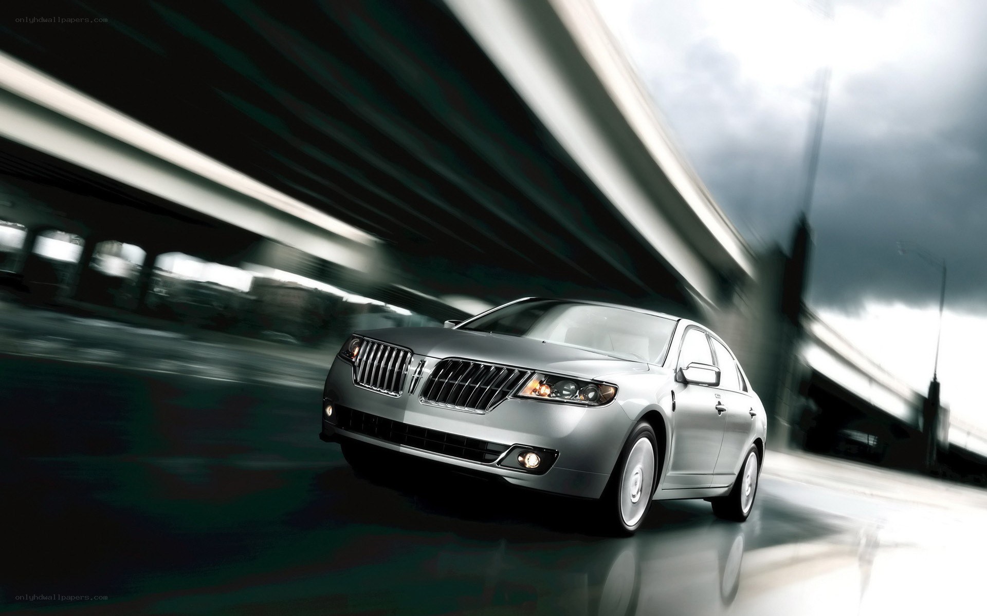 silver sedan under highway