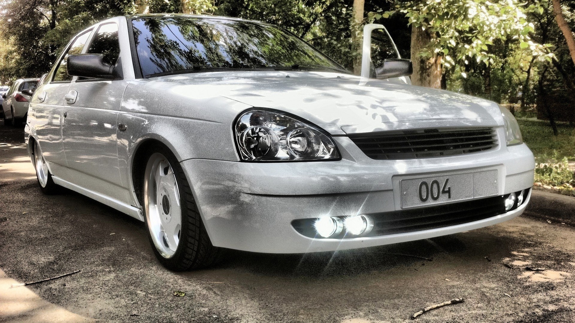 silver sedan with custom wheels