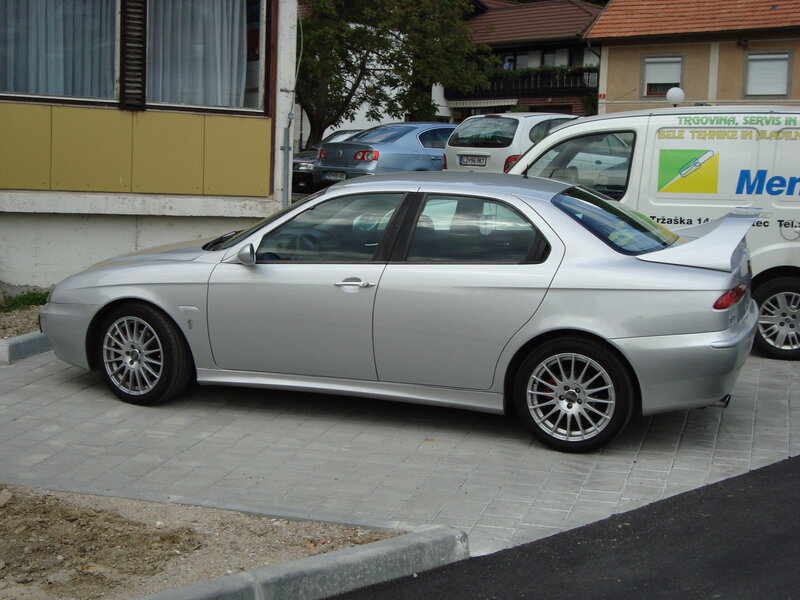 silver sedan with rear spoiler