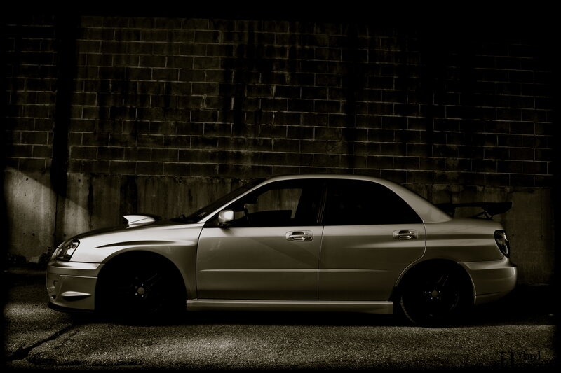 silver sedan with rear wing