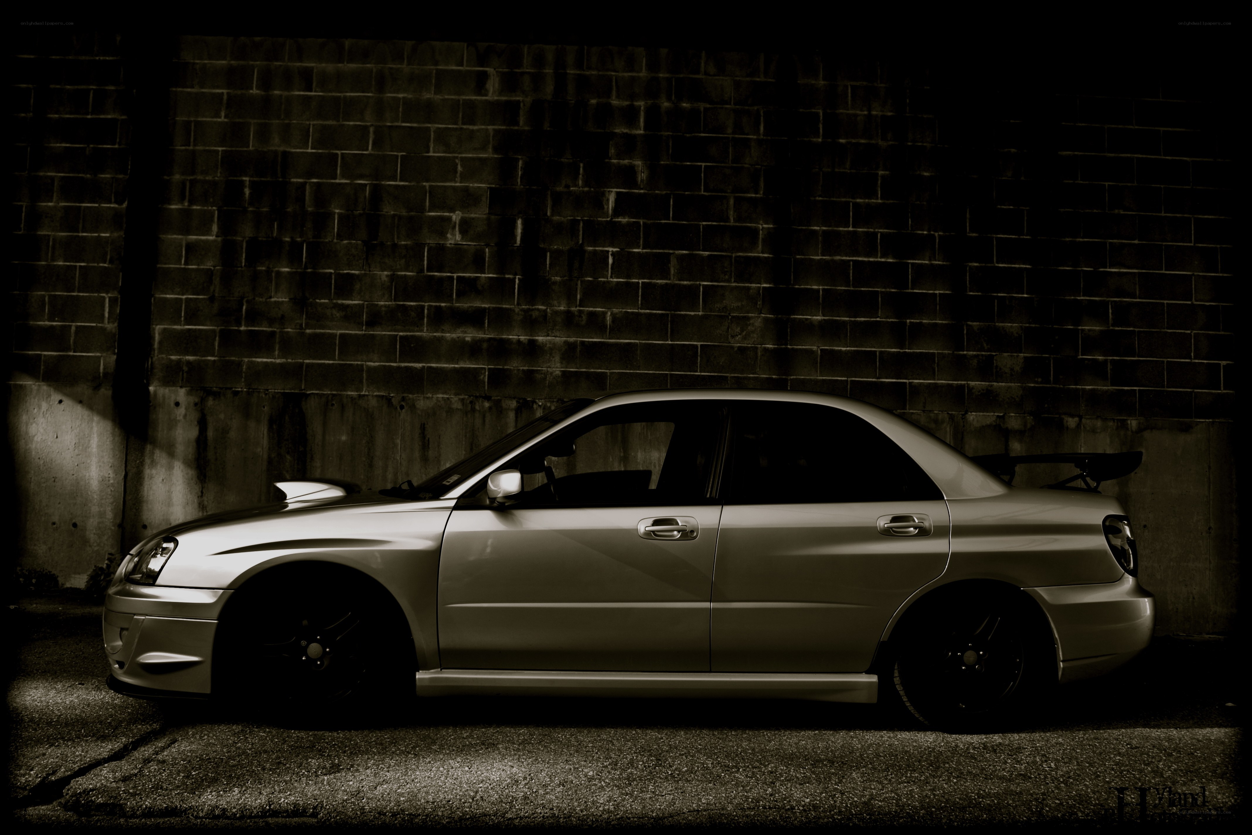 silver sedan with rear wing