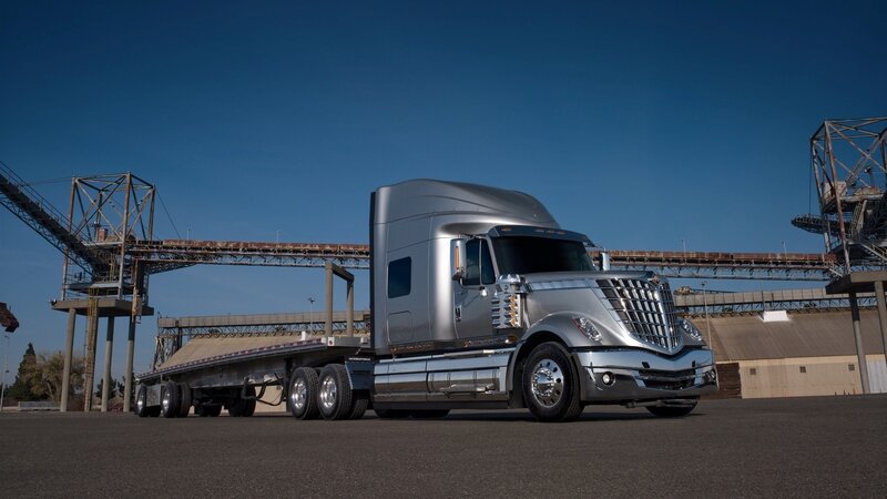 silver semi-truck in industrial yard